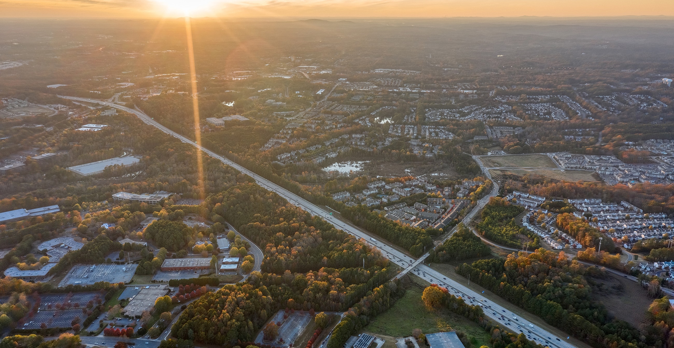 Aerial view of sunset over suburban landscape.