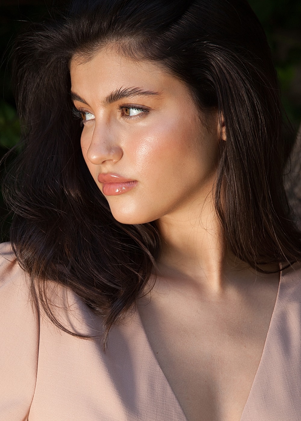 Profile of a young woman with glowing skin.
