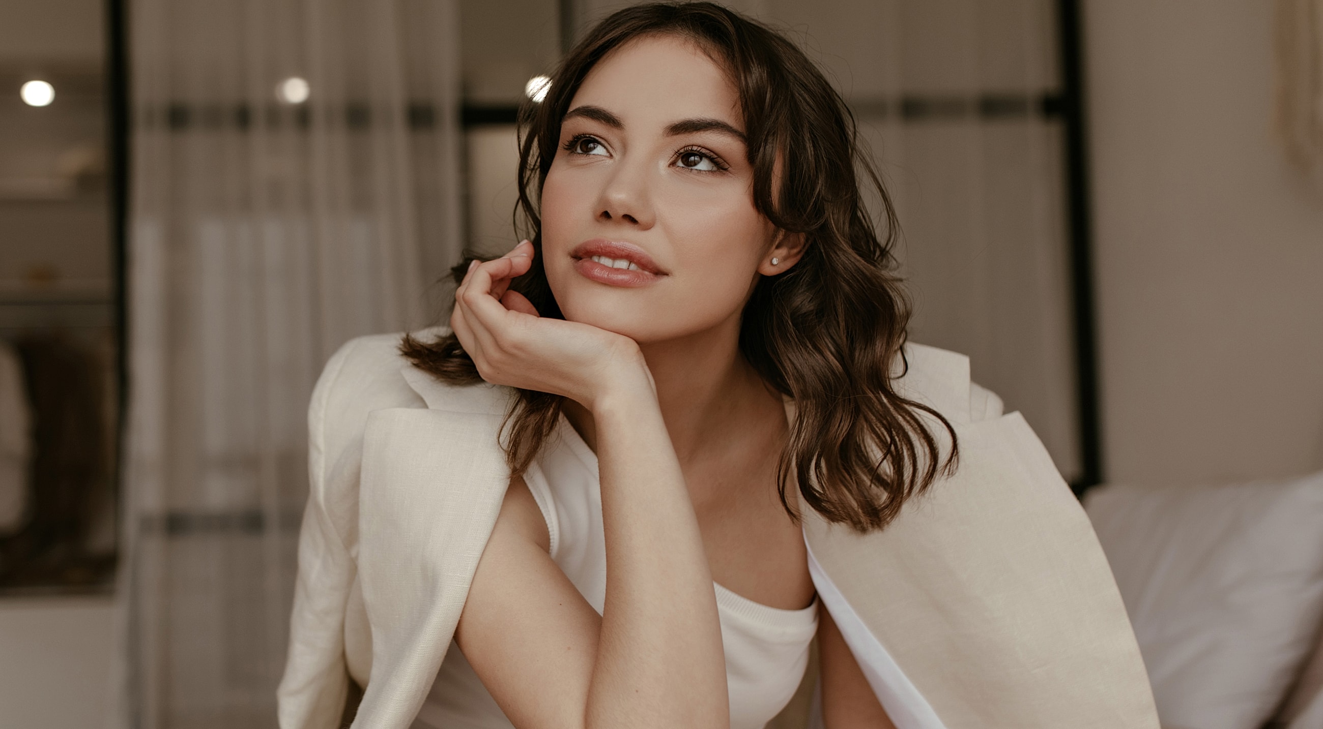 Woman thoughtfully resting her chin on her hand.